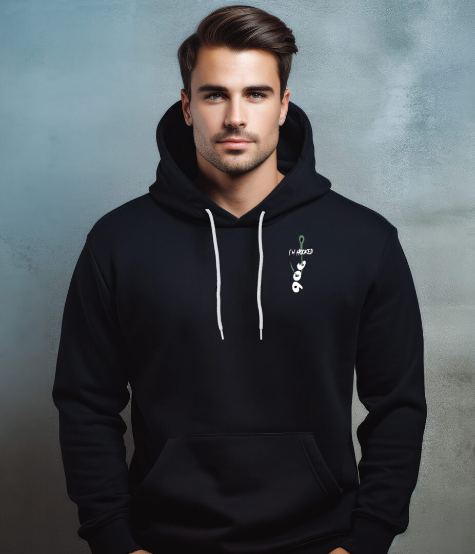 A man wearing a black hoodie with a cross on it.