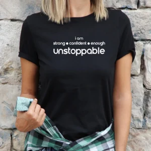 A woman wearing a black shirt with the words unstoppable on it.
