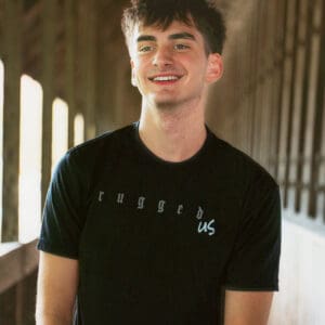 A man in black shirt smiling for the camera.