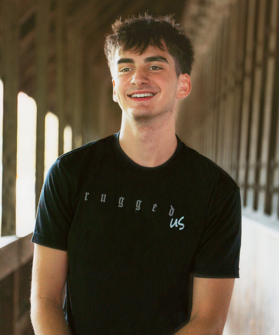 A man in black shirt smiling for the camera.