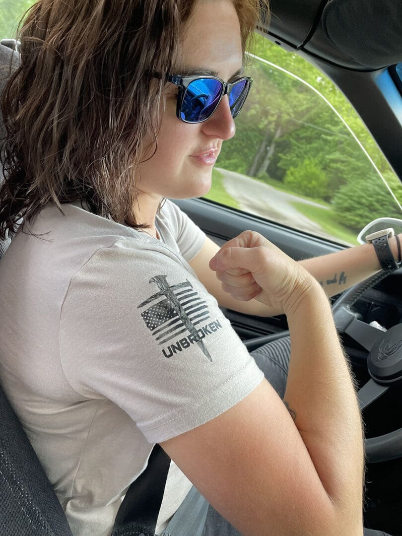 A woman sitting in the driver 's seat of her car.