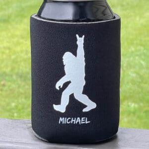 A can cooler with an image of a bigfoot.